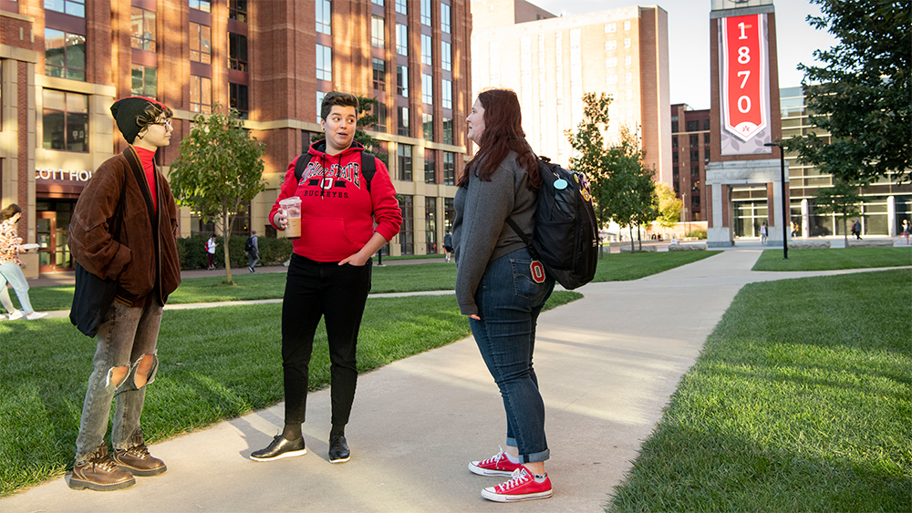 Brand photography shoot on North Campus with models Kala McClure (red hoodie), Ashley Stroud (grey shirt) and Lulu Montes (red hat) North Campus